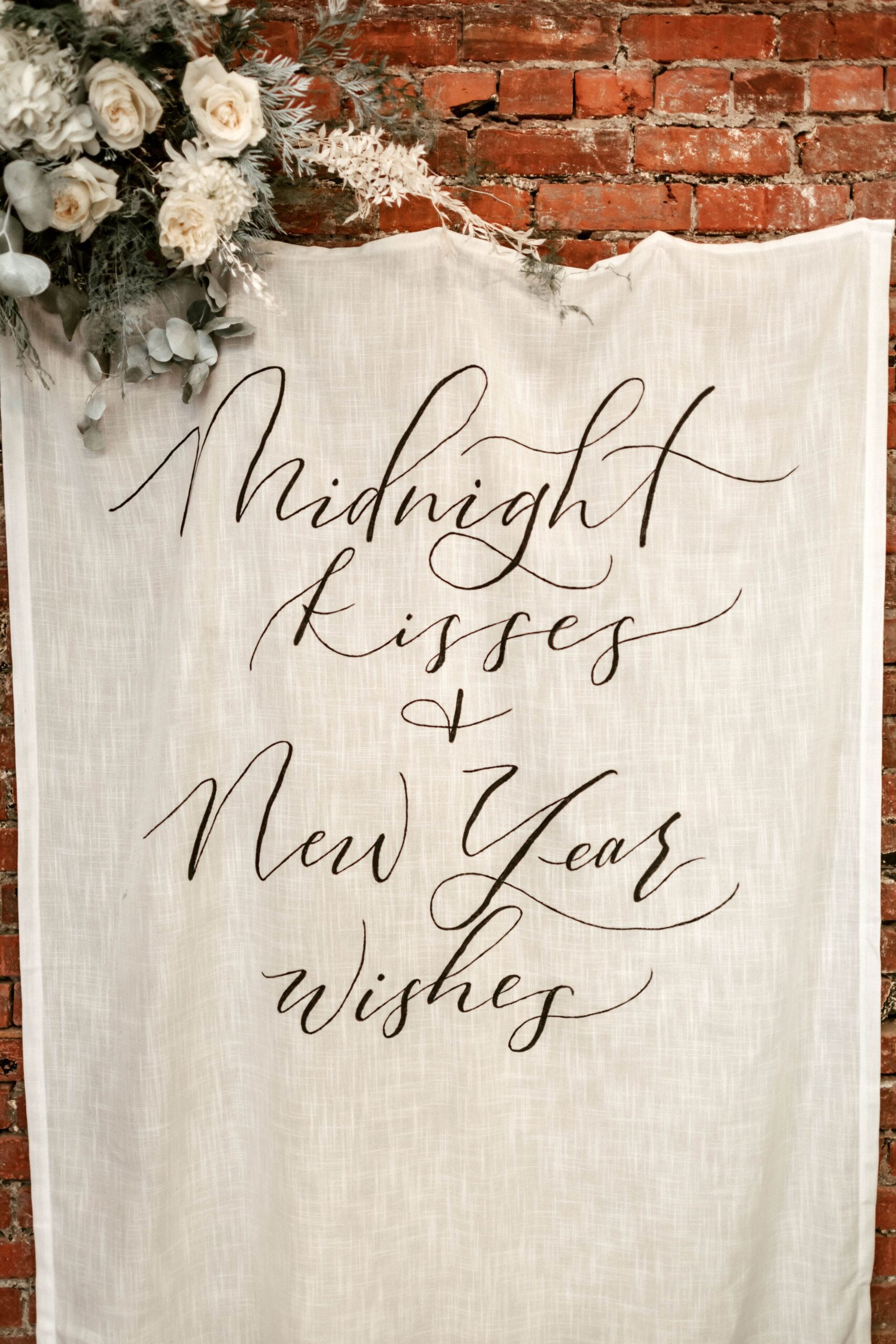  custom calligraphy banner saying midnight kisses and New Years wishes 
